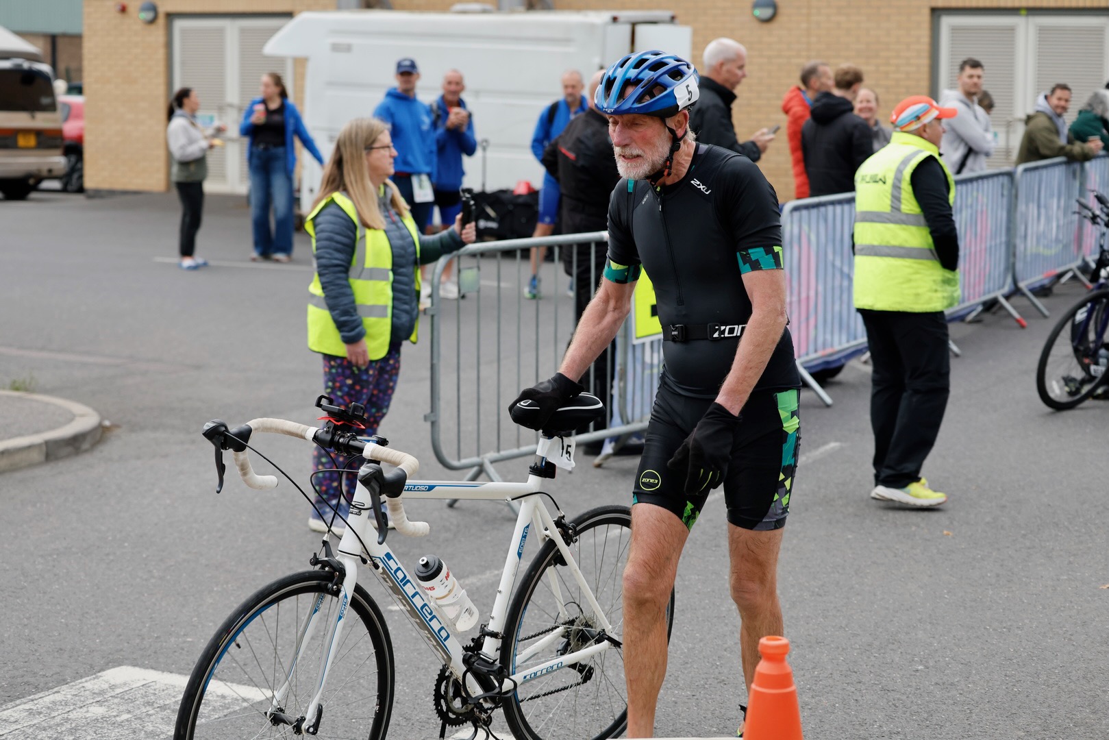 An athlete with a road bike at the Crowle Triathlon bike finish